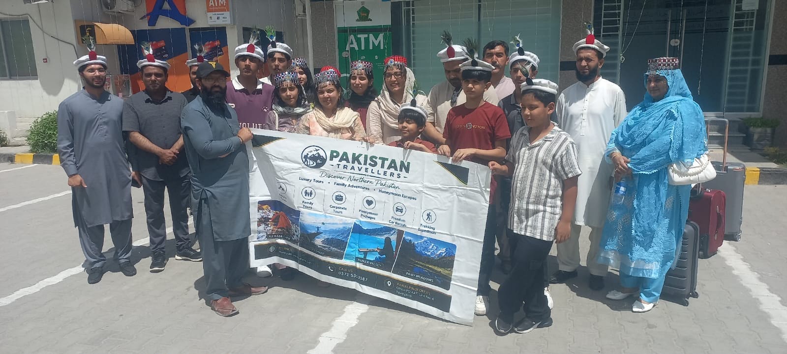 A large family group in traditional Hunza caps before departing for the north